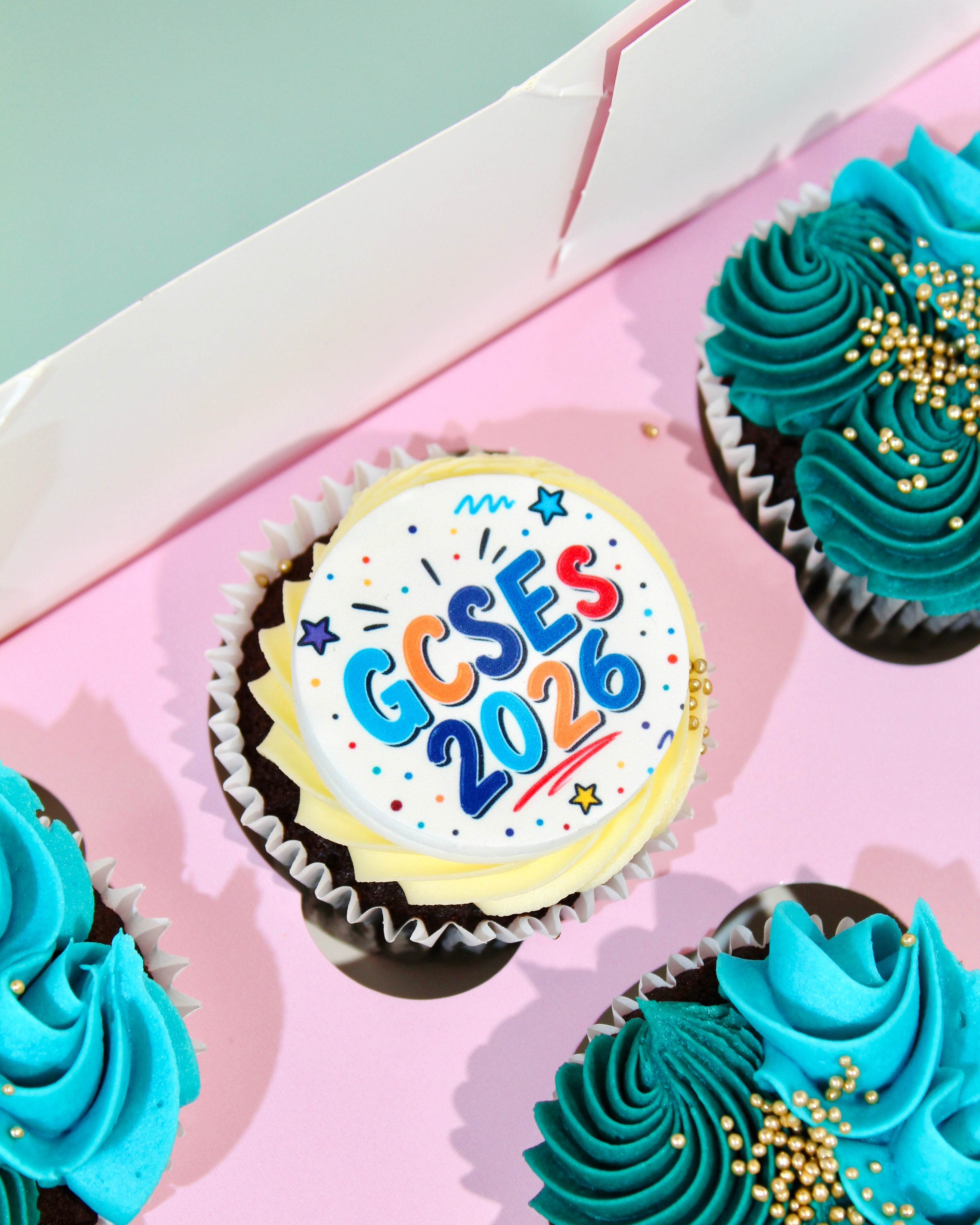 Amy's Bakehouse Exam Season collection featuring GCSE and A Level celebration cupcakes in teal and blue buttercream