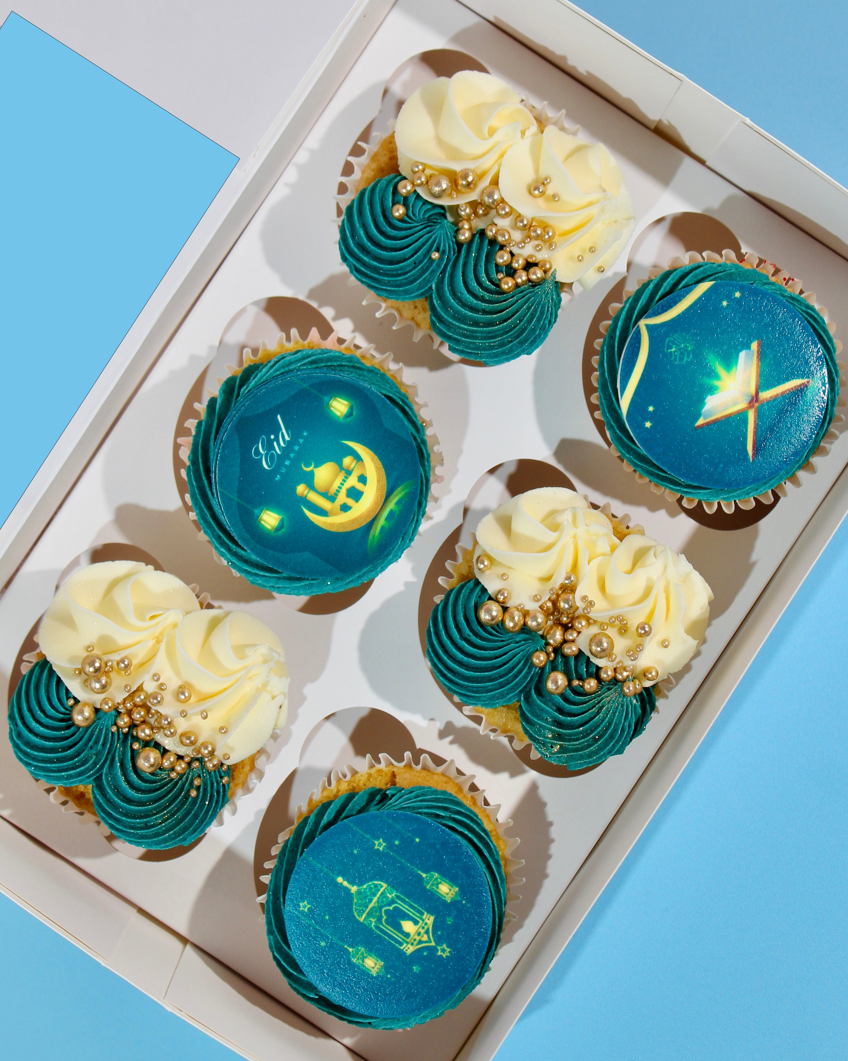 Luxury Eid cupcakes with teal buttercream, gold detailing and Eid Mubarak toppers
