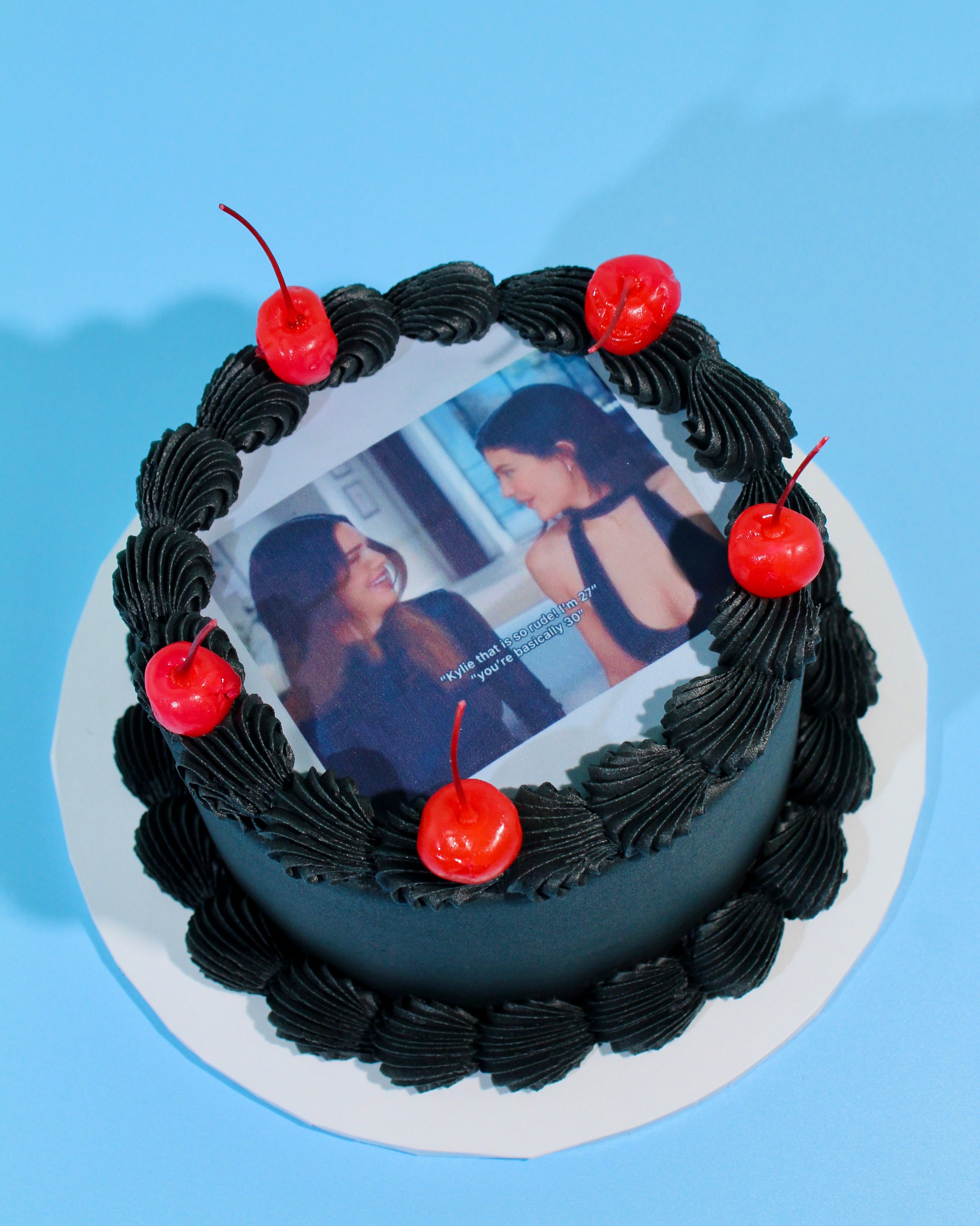 Black “You’re Basically 30” cake with cherries and custom edible photo topper for milestone birthdays.