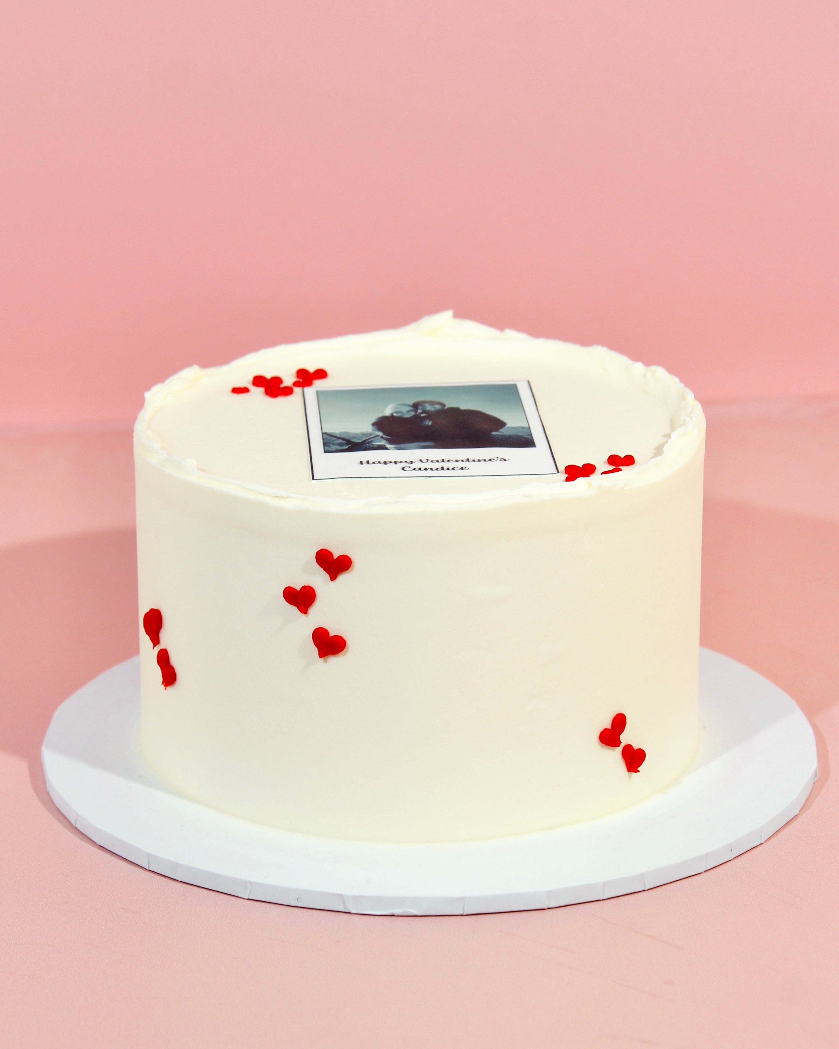 Romantic Valentine’s cake with edible hearts and photo topper