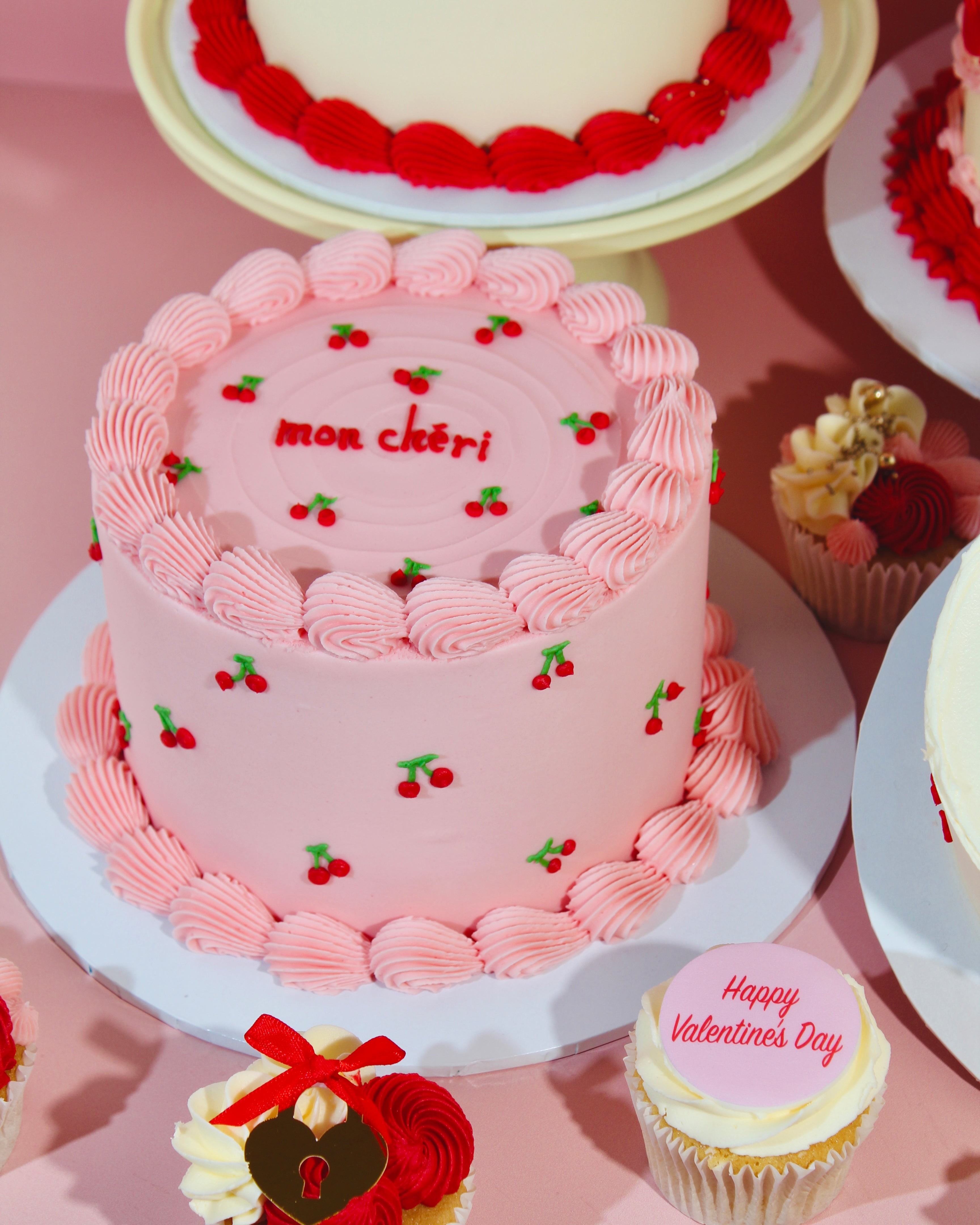 Close-up of Mon Chèri cake showing cherry details and smooth pink finish