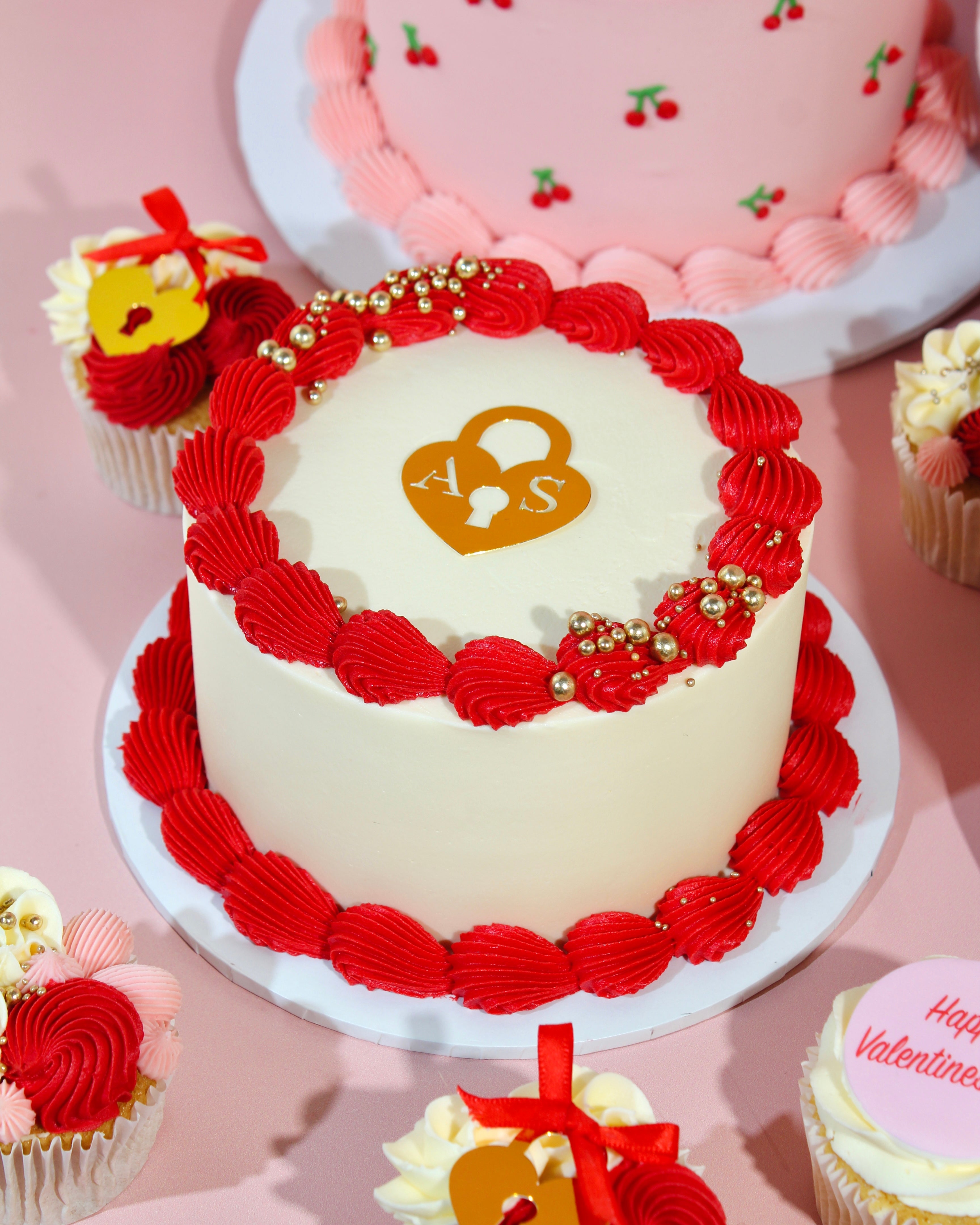 Heart locket Valentine’s cake with red piping, handmade in St Albans bakery