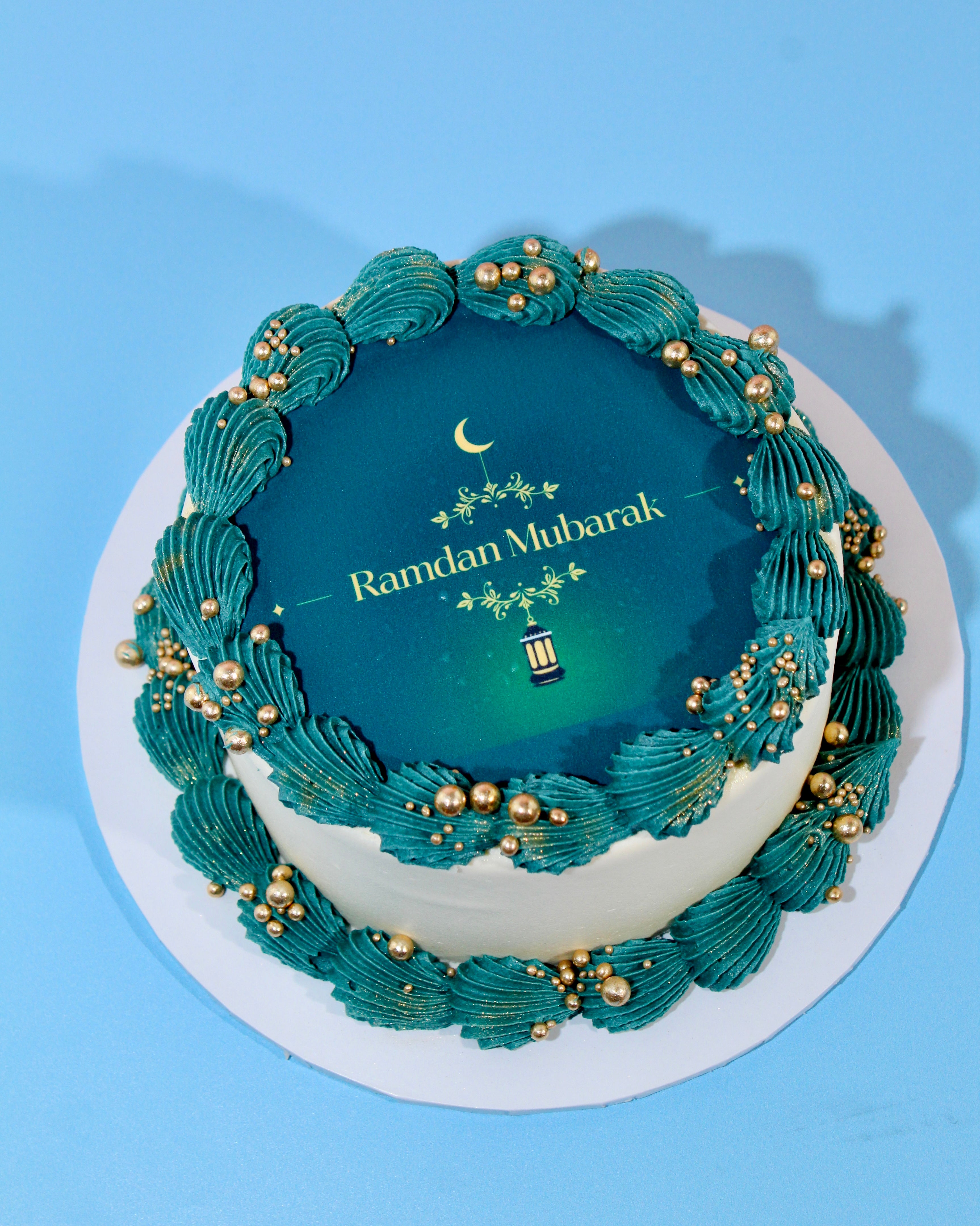 Ramadan Mubarak cake with teal buttercream piping and gold accents
