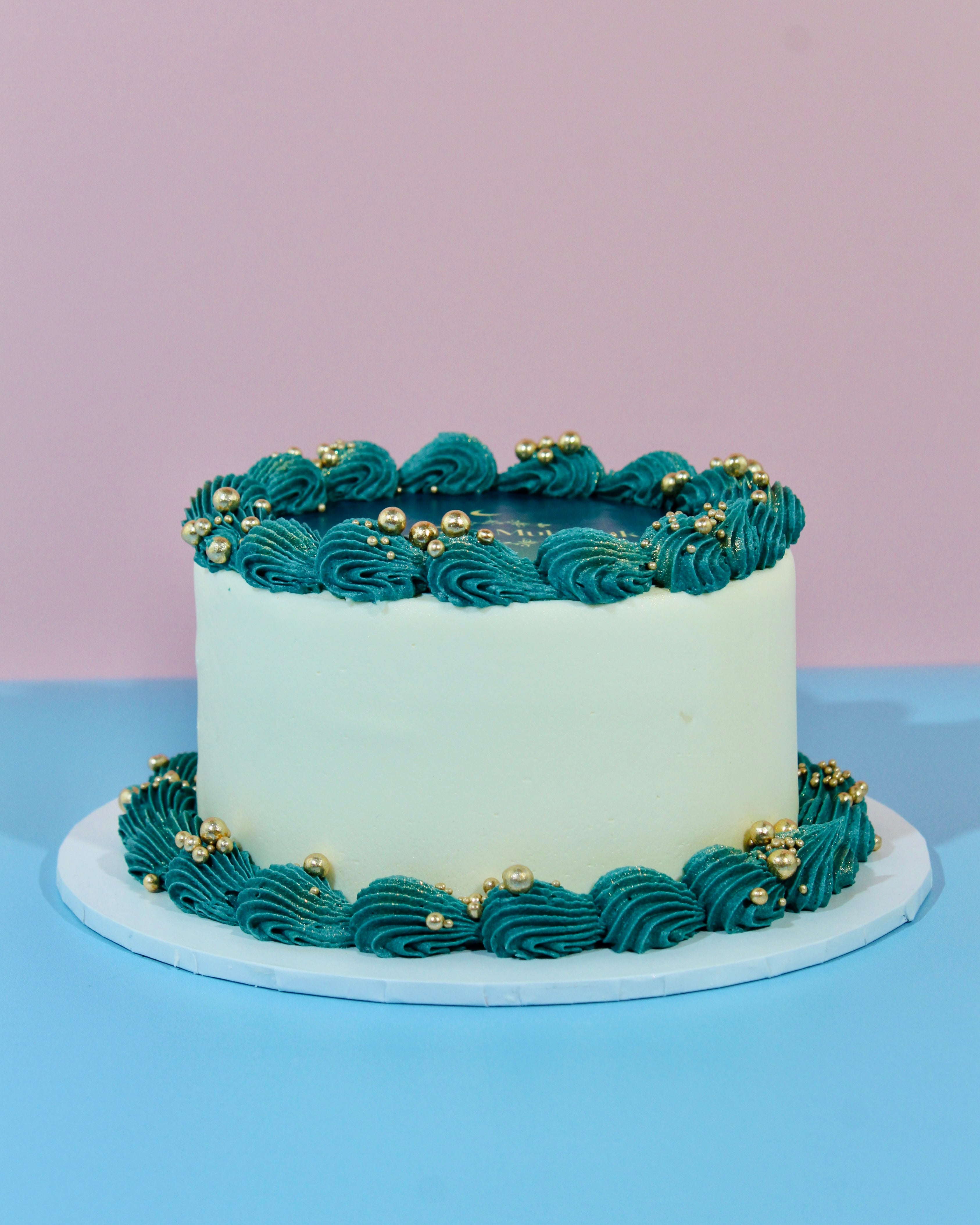 Luxury Eid cake with edible Eid Mubarak topper and buttercream swirls