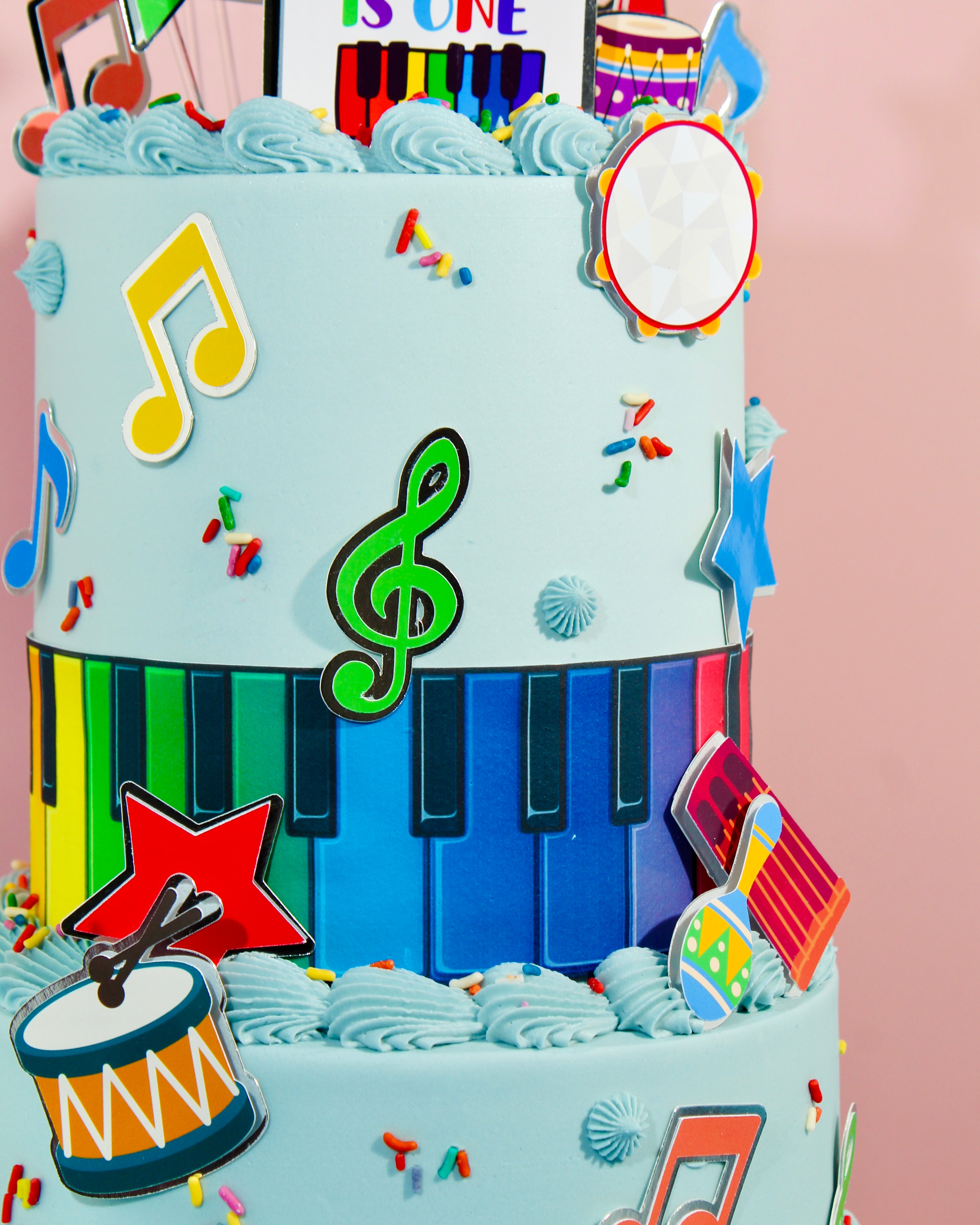 Close-up of music cake showing piano keys, musical notes and bright decorations