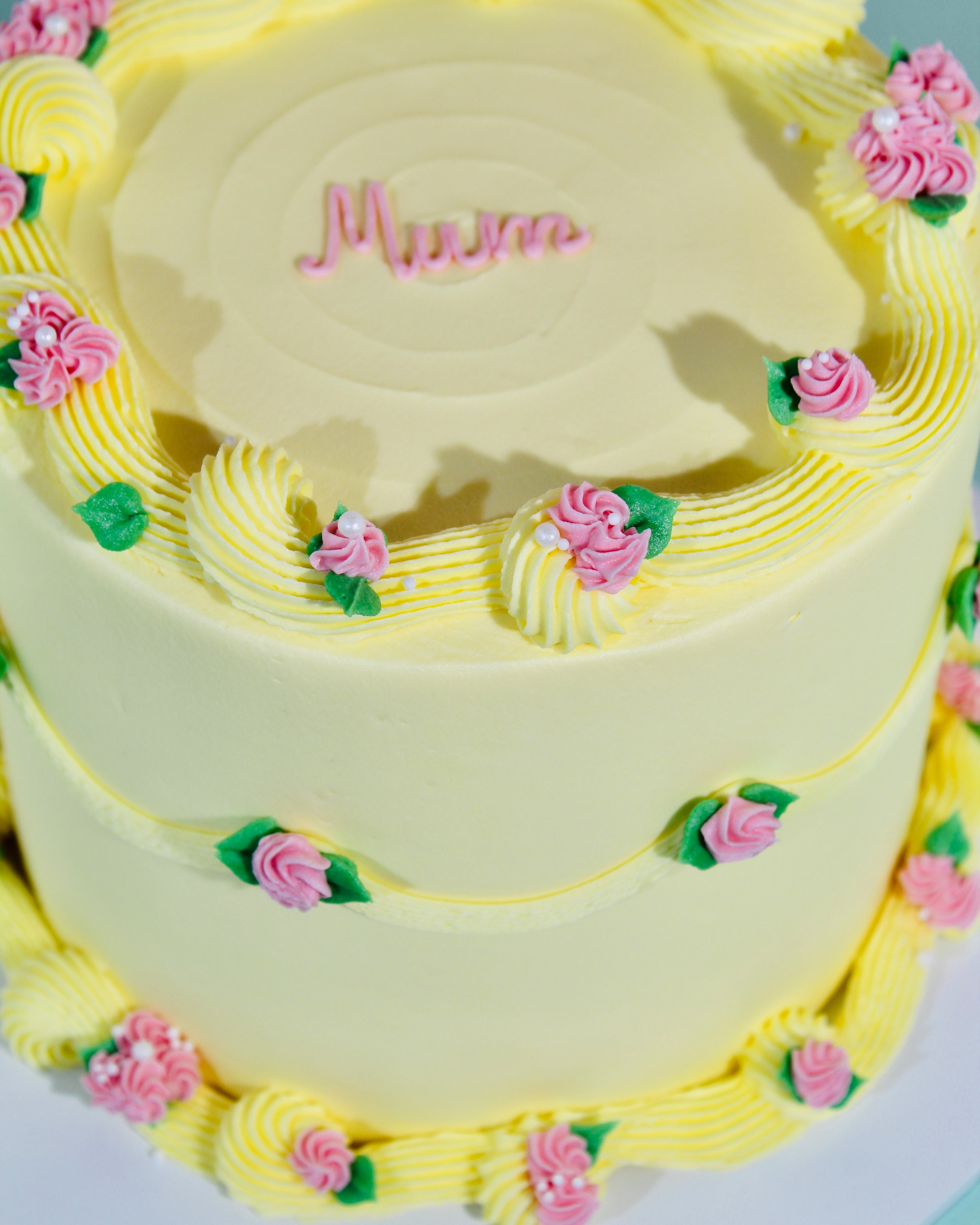 Floral buttercream cake with piped roses and personalised name