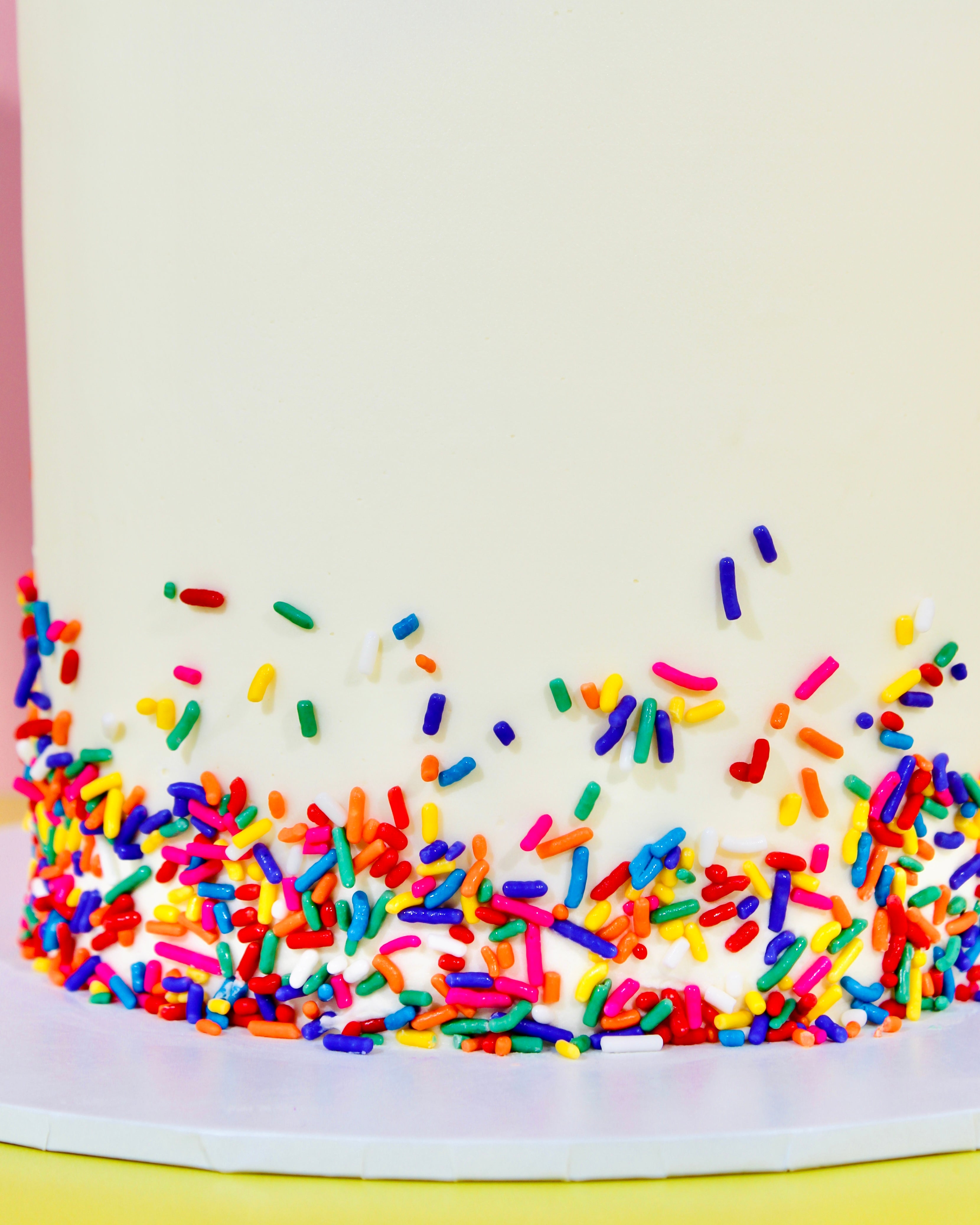 Vanilla cake with buttercream rosettes topped with cherries and sprinkles