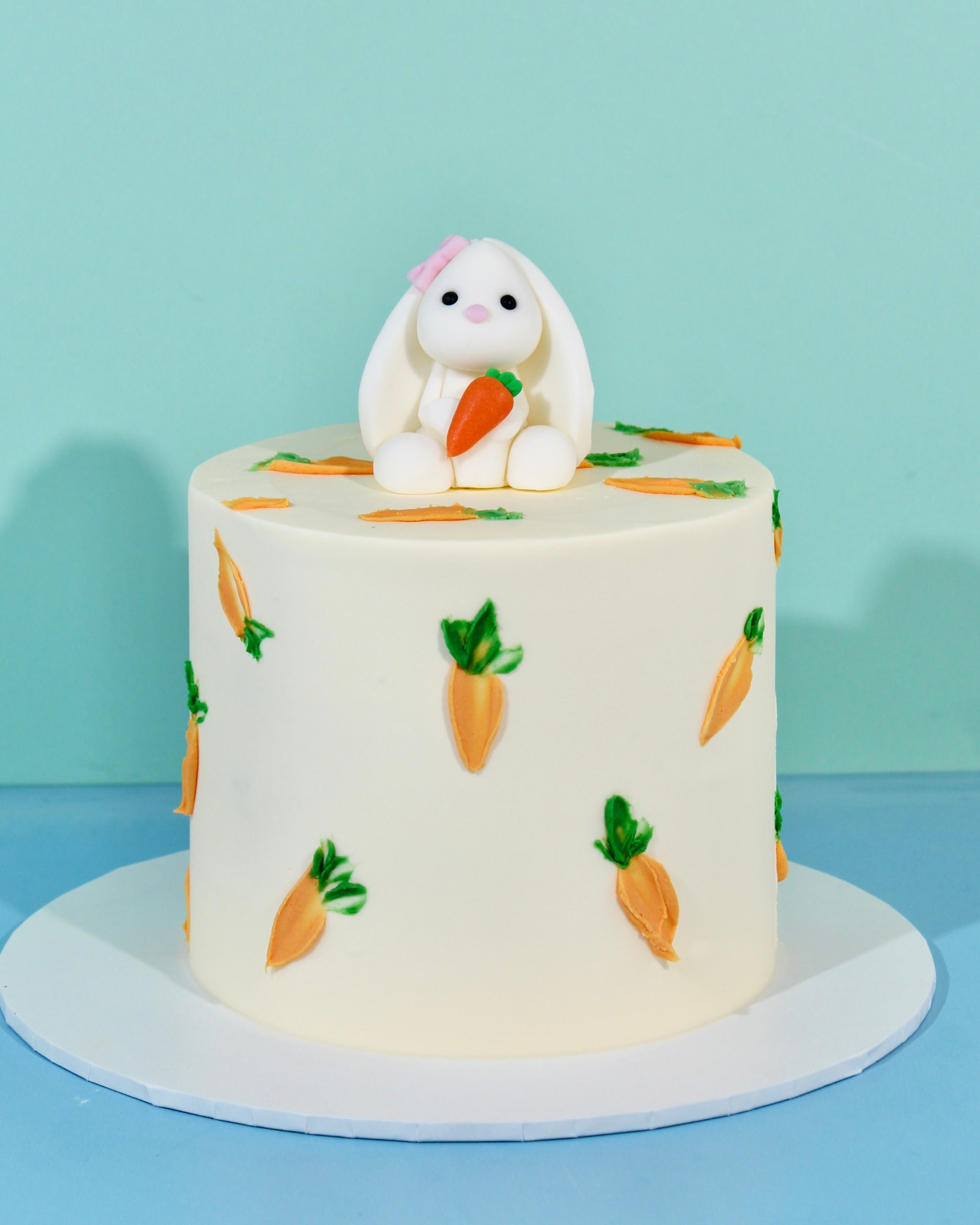 Easter cake with bunny topper and carrot decorations