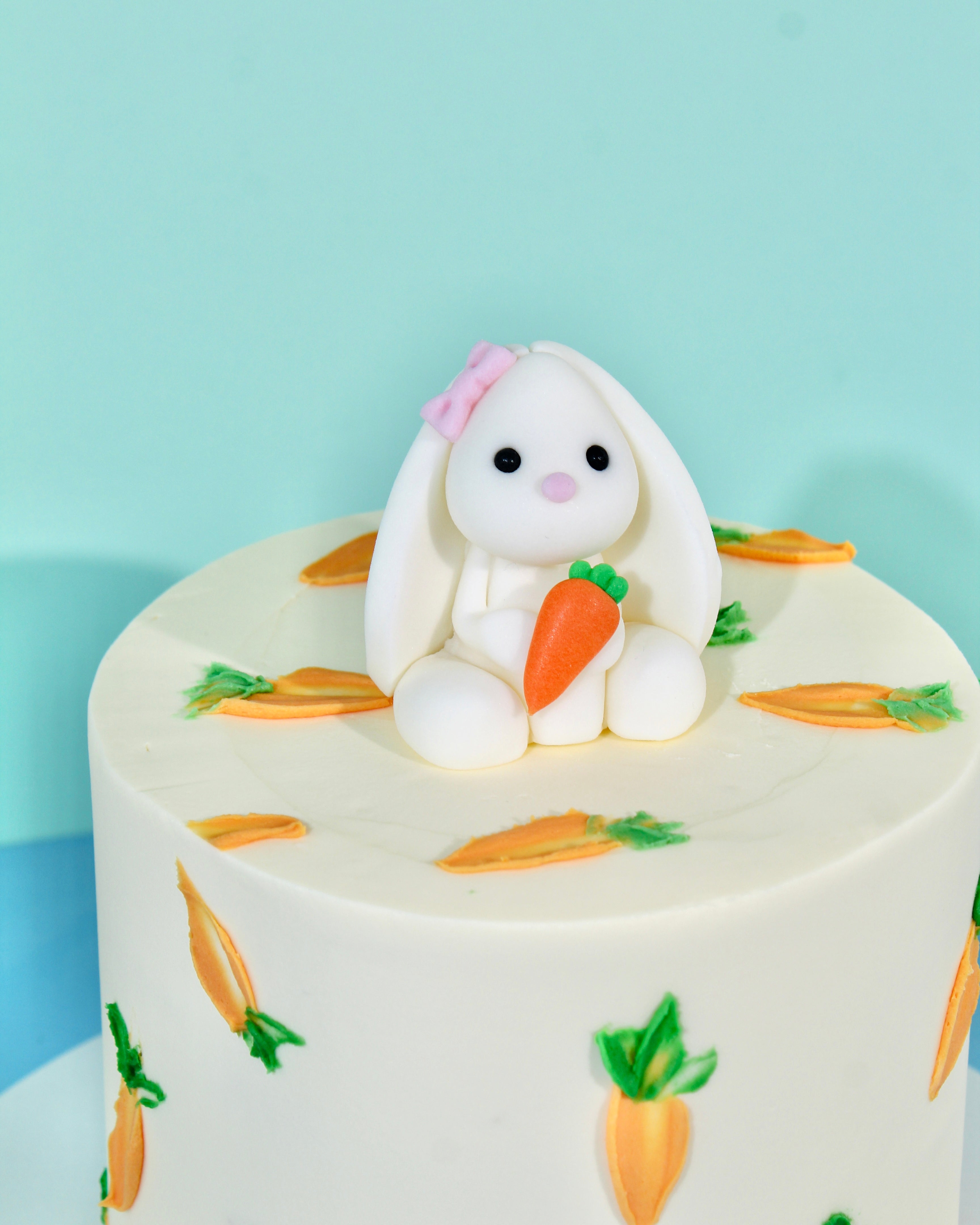 Cute bunny Easter cake with buttercream carrots