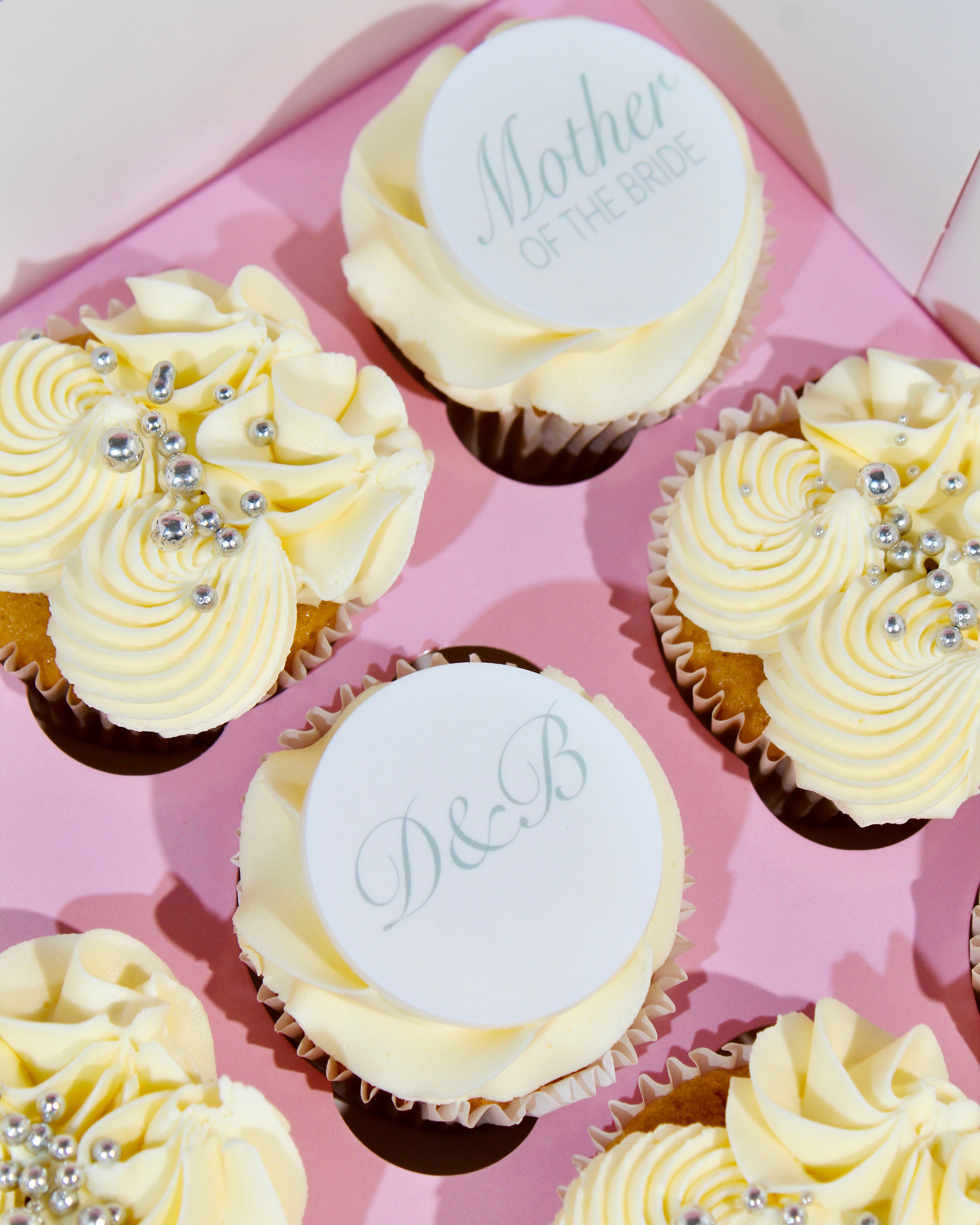 Mother of the bride cupcakes with ivory buttercream swirls, silver sugar pearls and personalised edible toppers