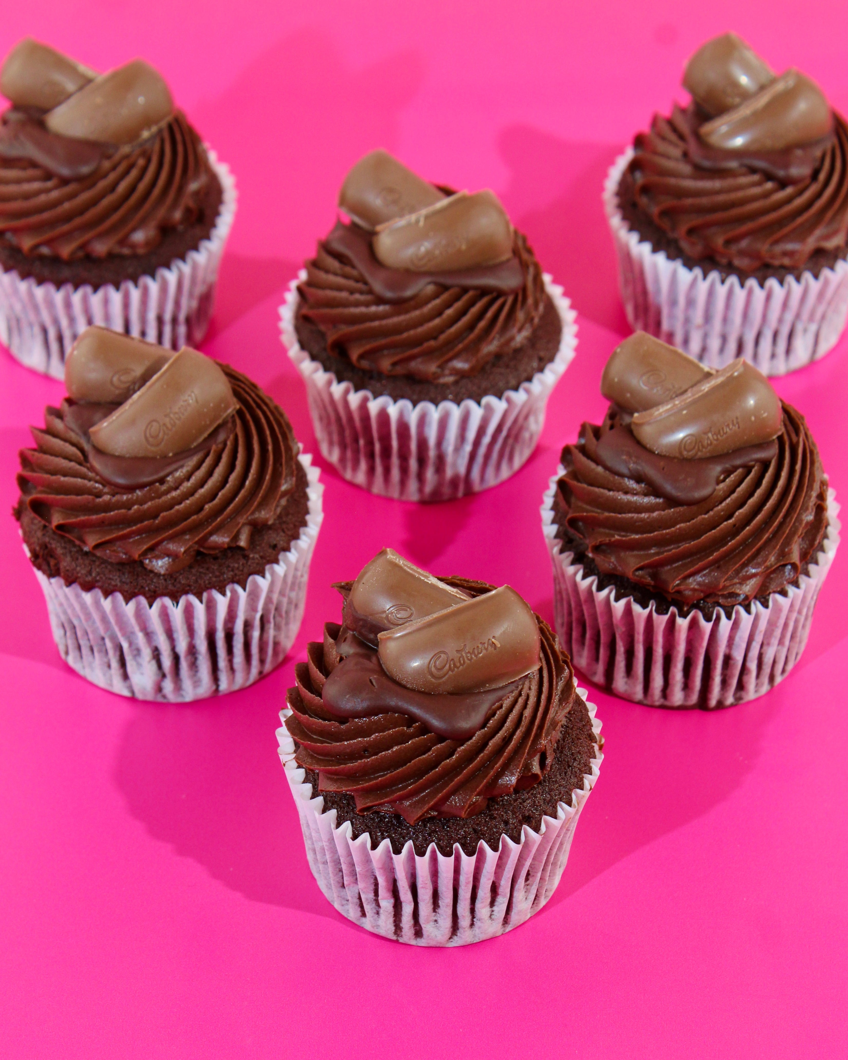 Close up of chocolate cupcake with chocolate buttercream and Cadbury topping