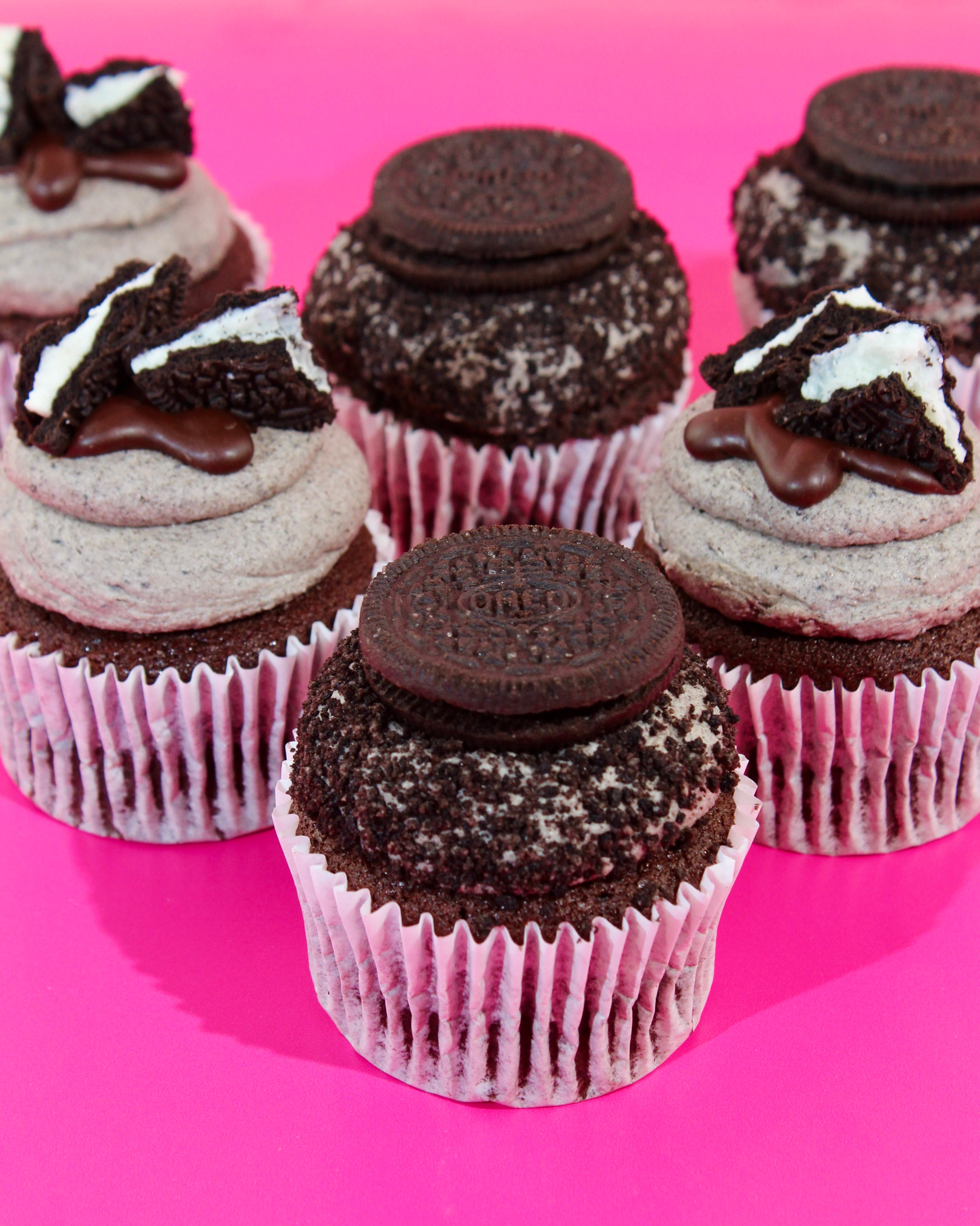 Cupcakes with Oreo cookies on a pink background