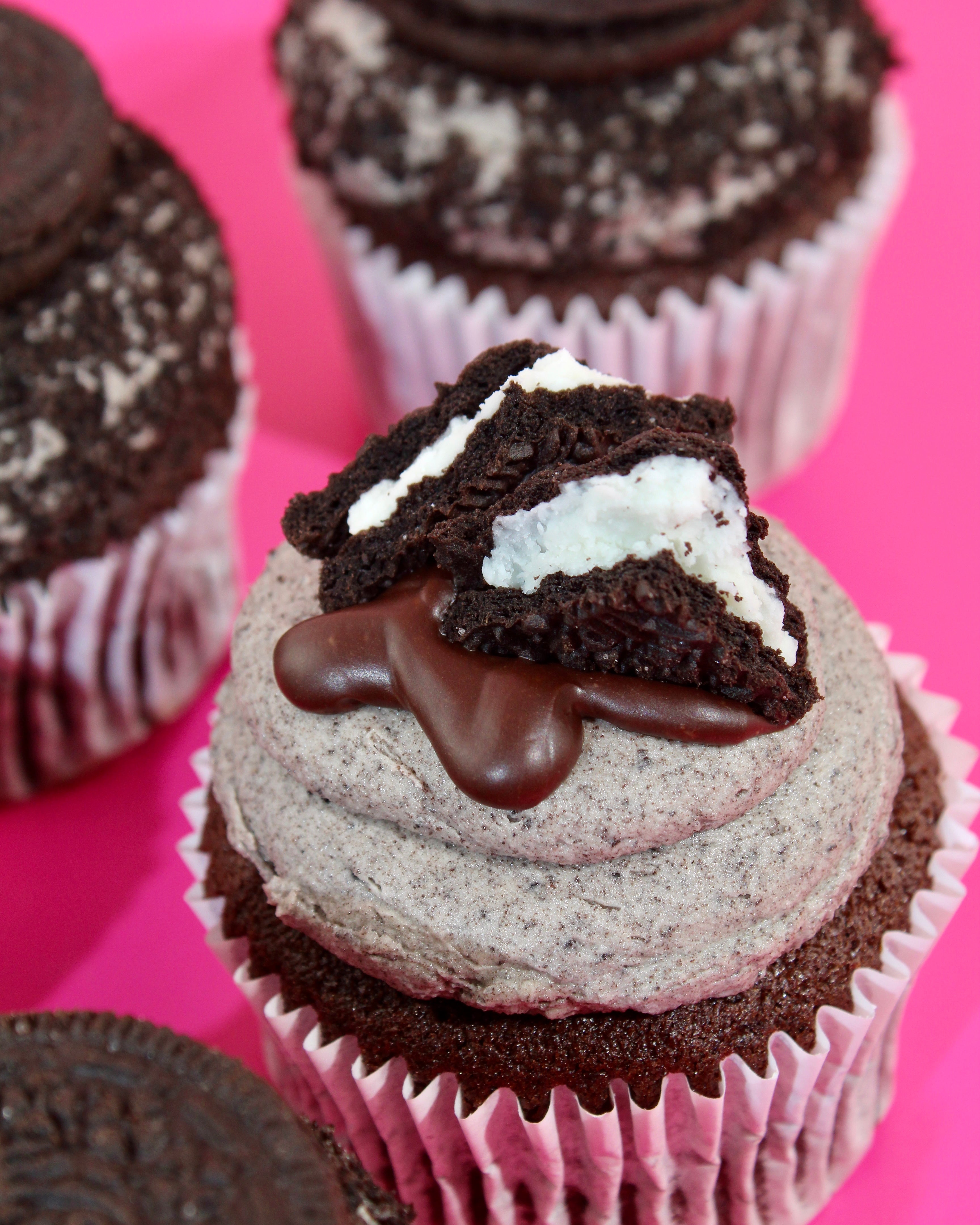 Chocolate cupcake with Oreo topping on a pink background