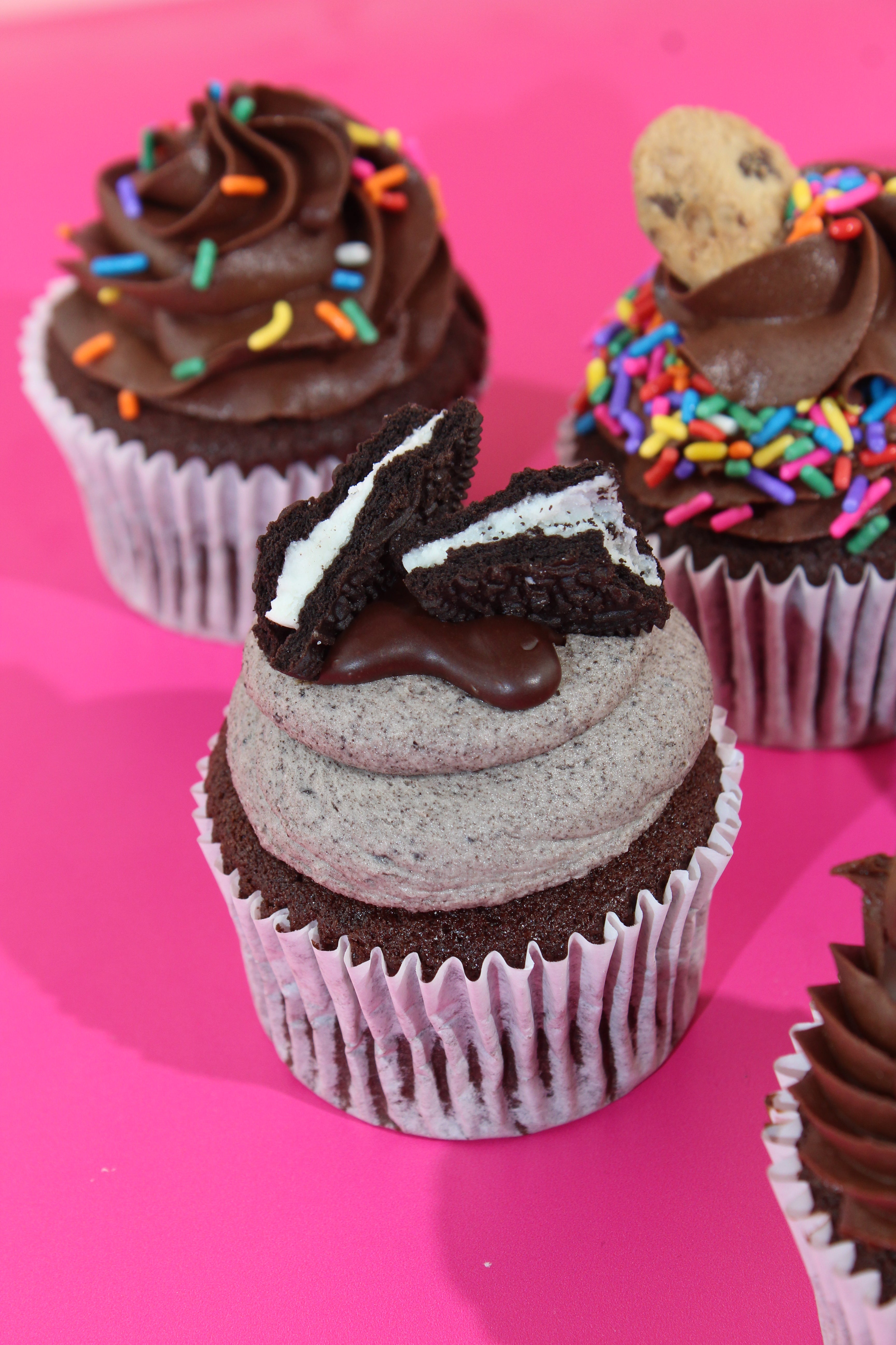 Assorted chocolate cupcakes with toppings including Oreo, Kinder and Biscoff