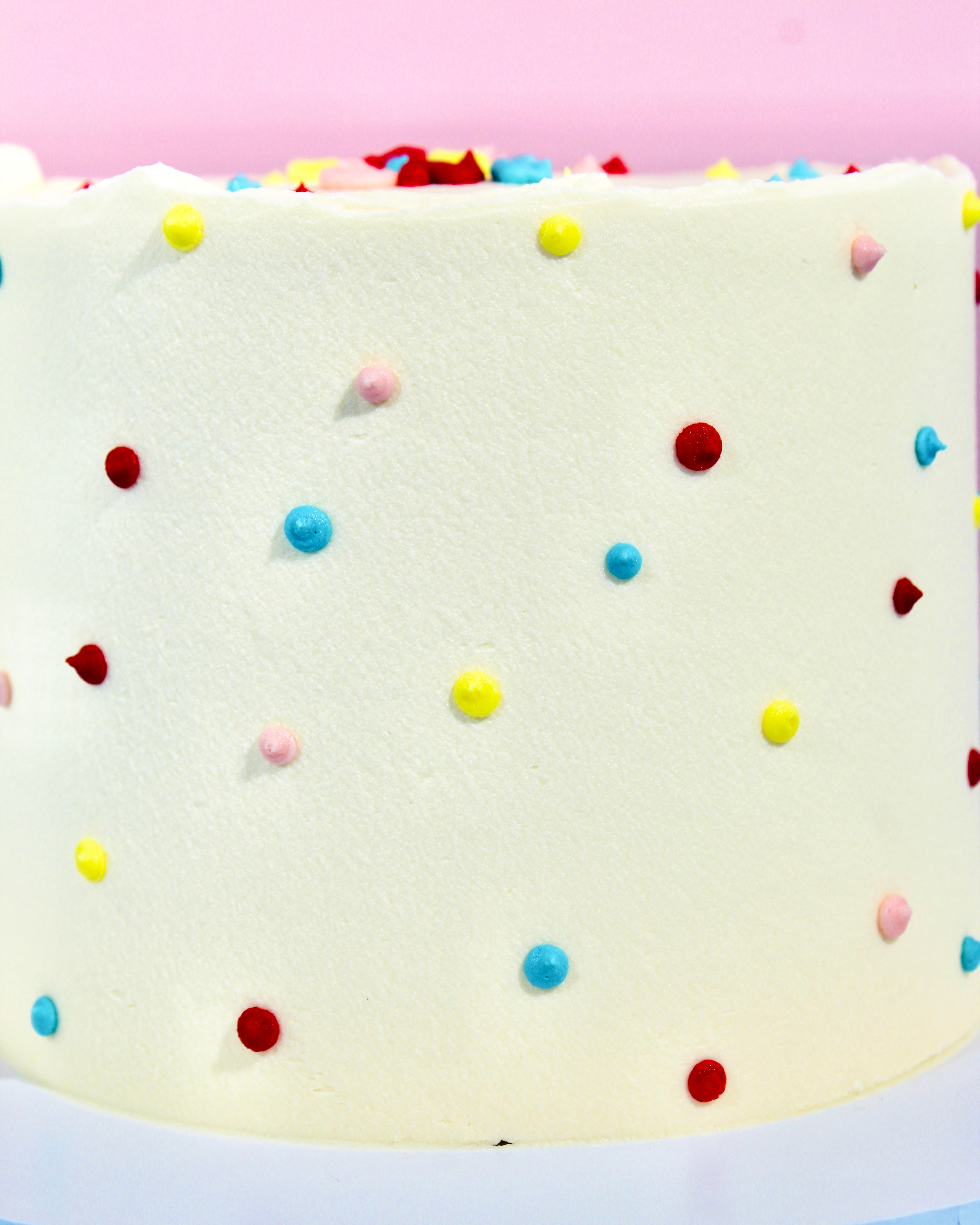 Minimal Pride cake with rainbow polka dot design