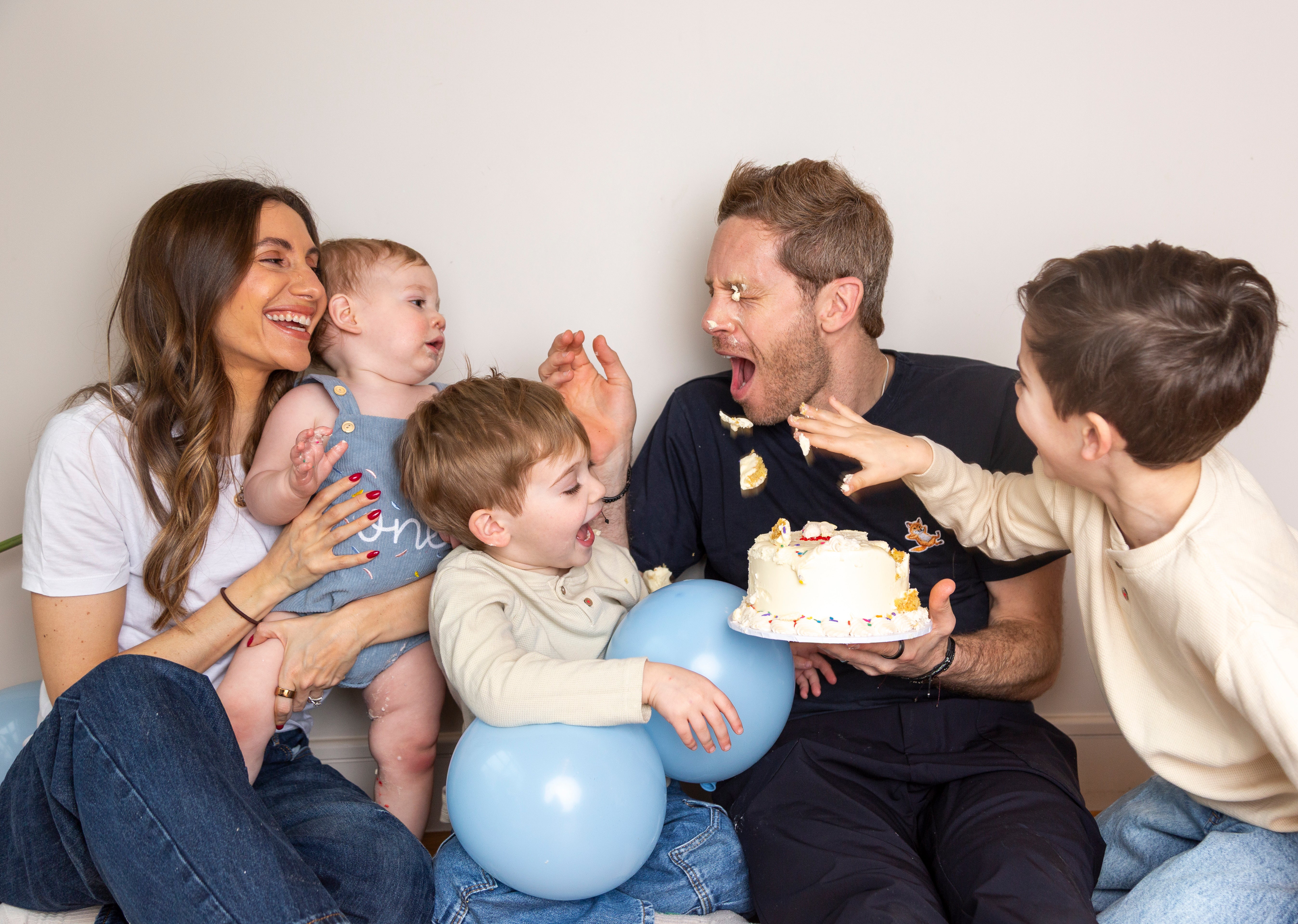 Baby smash cake with white buttercream, piped borders and colourful rainbow sprinkles