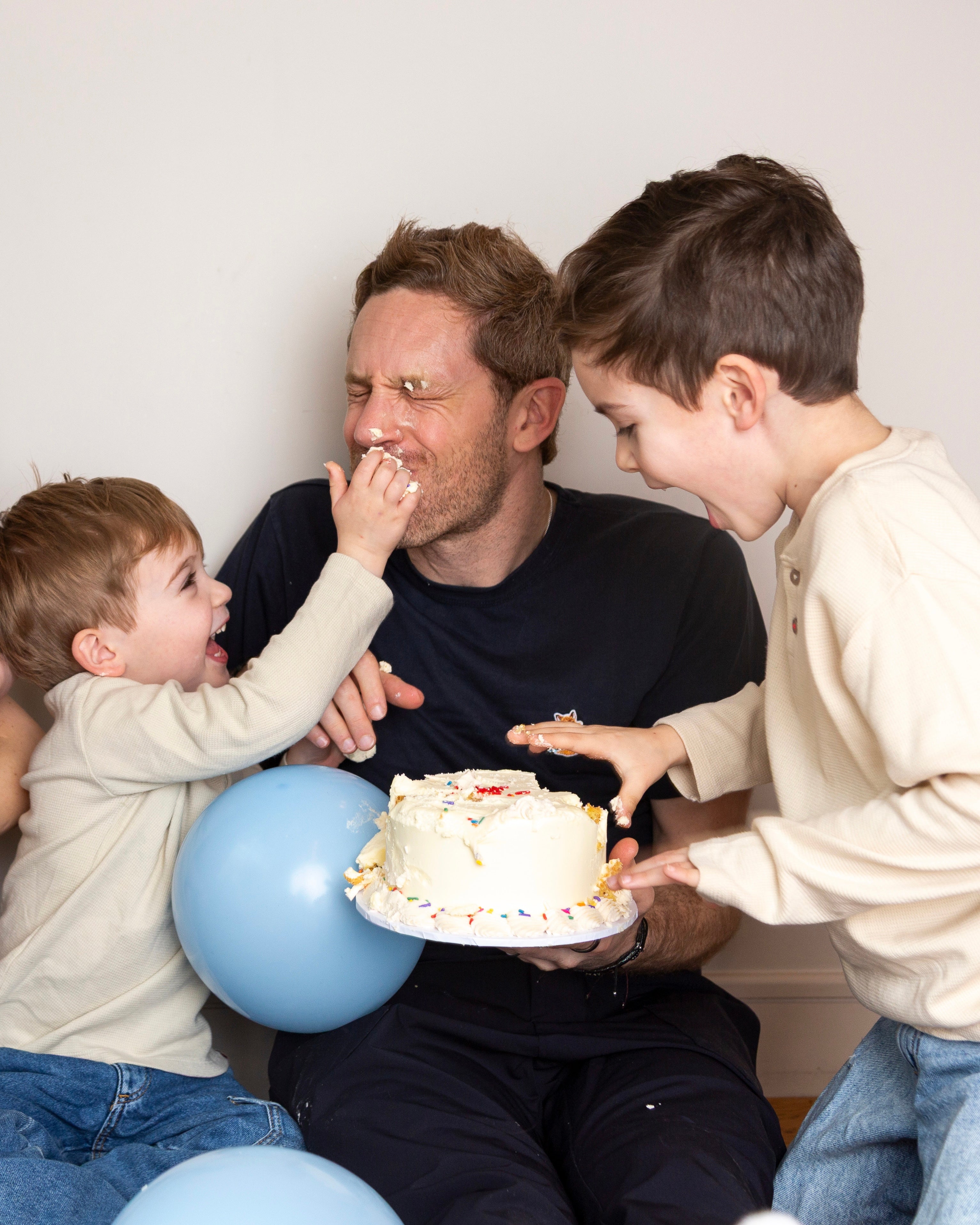 Close up of buttercream piping with rainbow sprinkles on baby smash cake