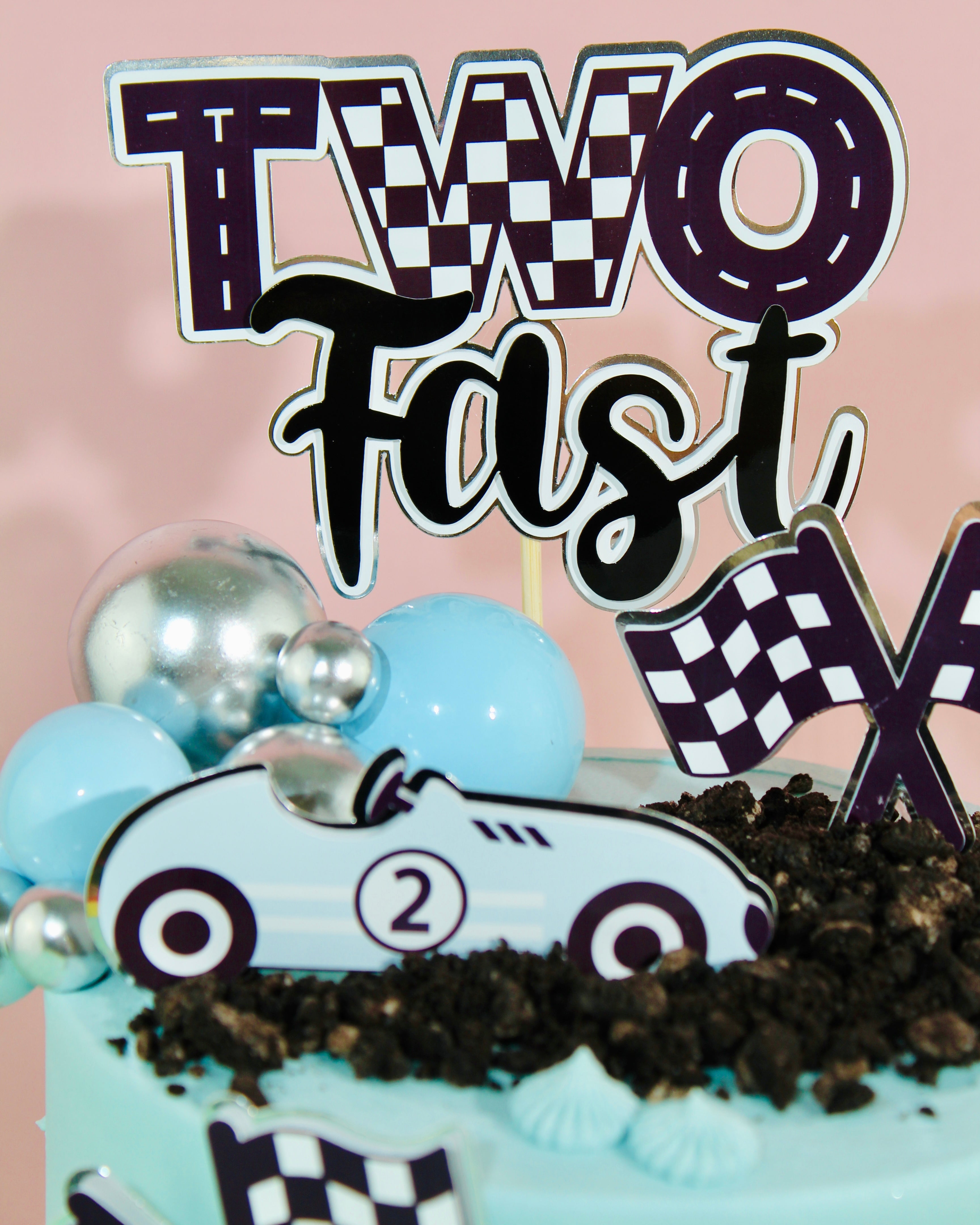 Race car themed second birthday cake with personalised iced board message