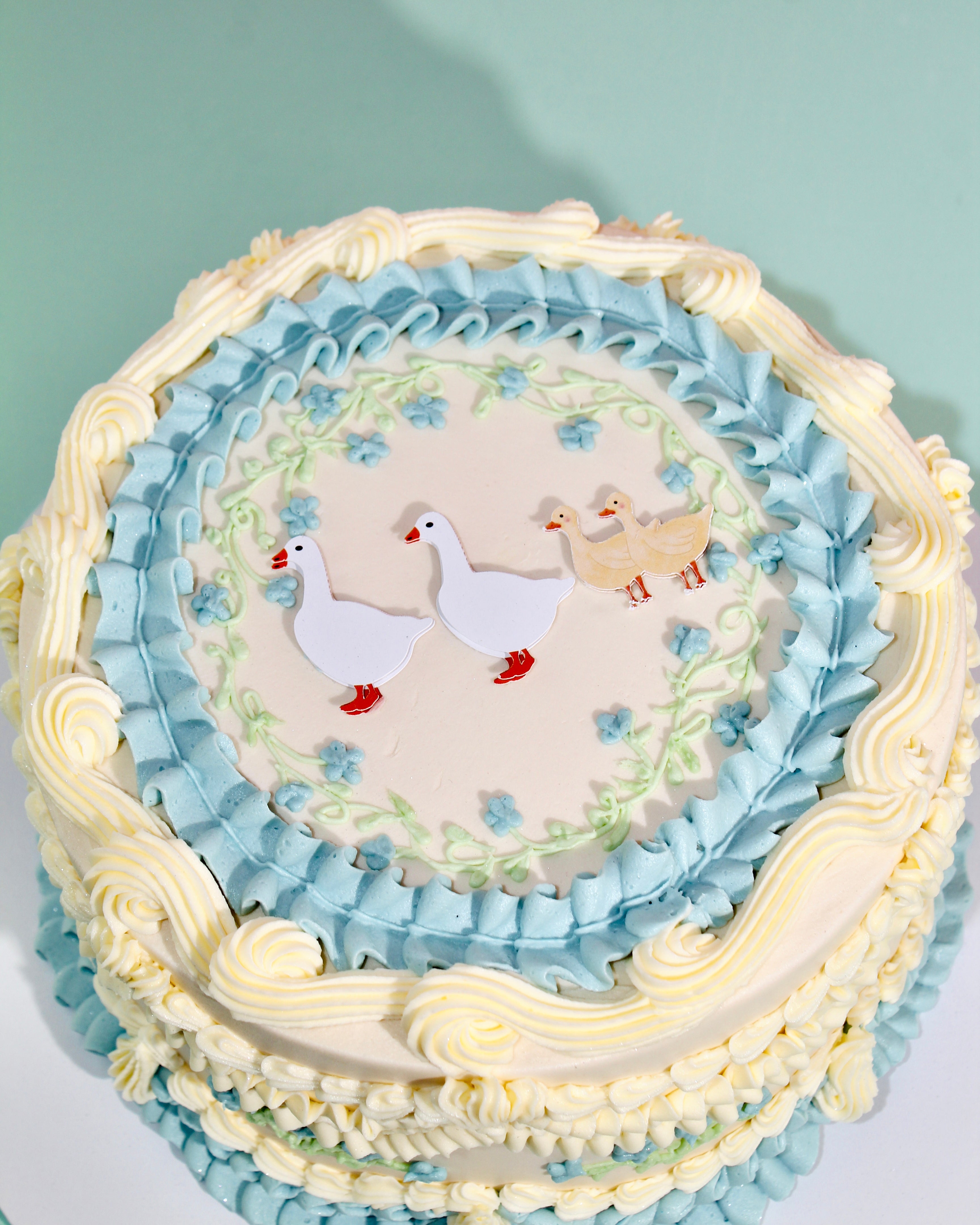 Charming cake with intricate piped buttercream and personalised iced message