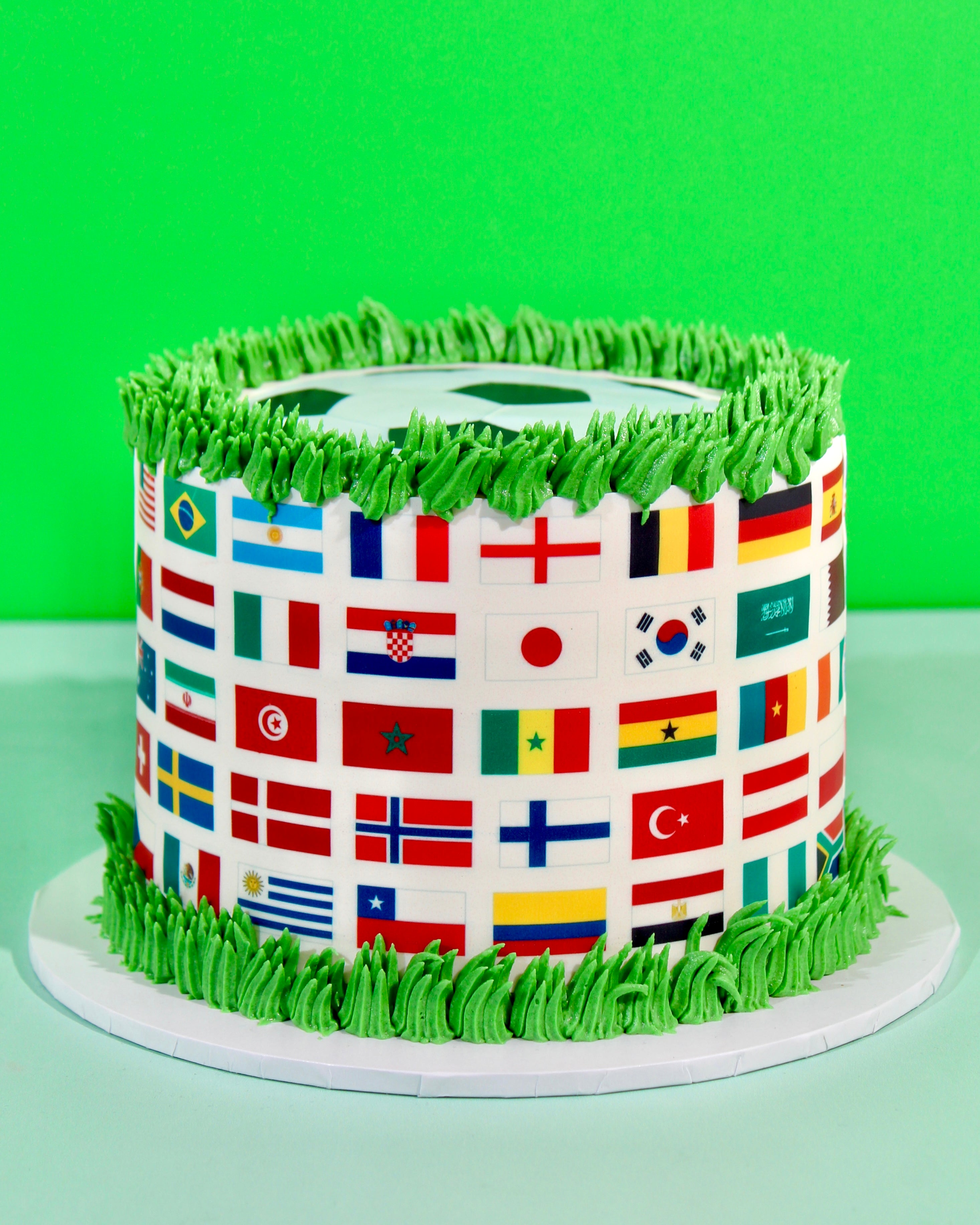 Close-up of international flags printed wrap around World Cup football celebration cake