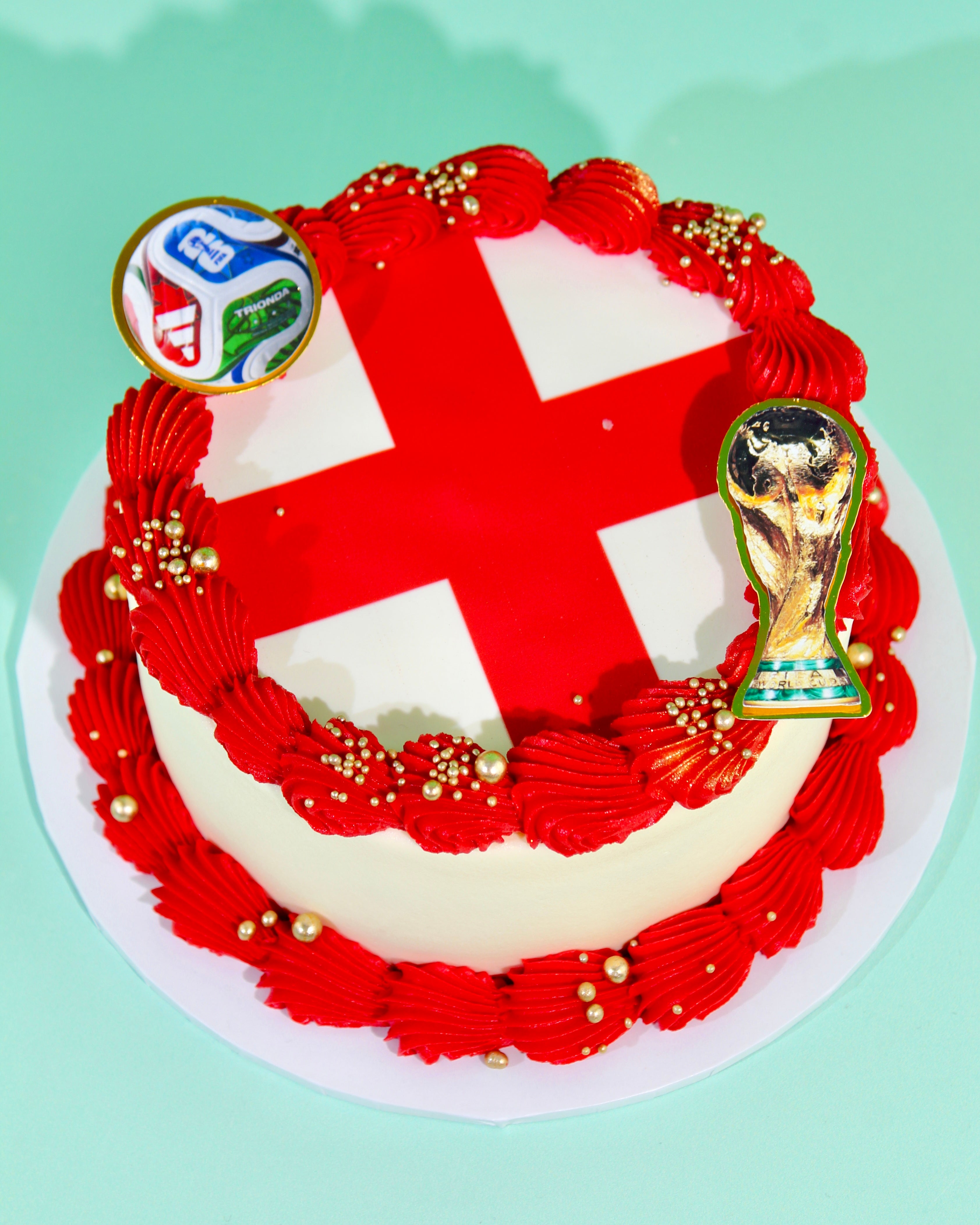 Cake with red and white design, featuring a trophy and logo on a light green background
