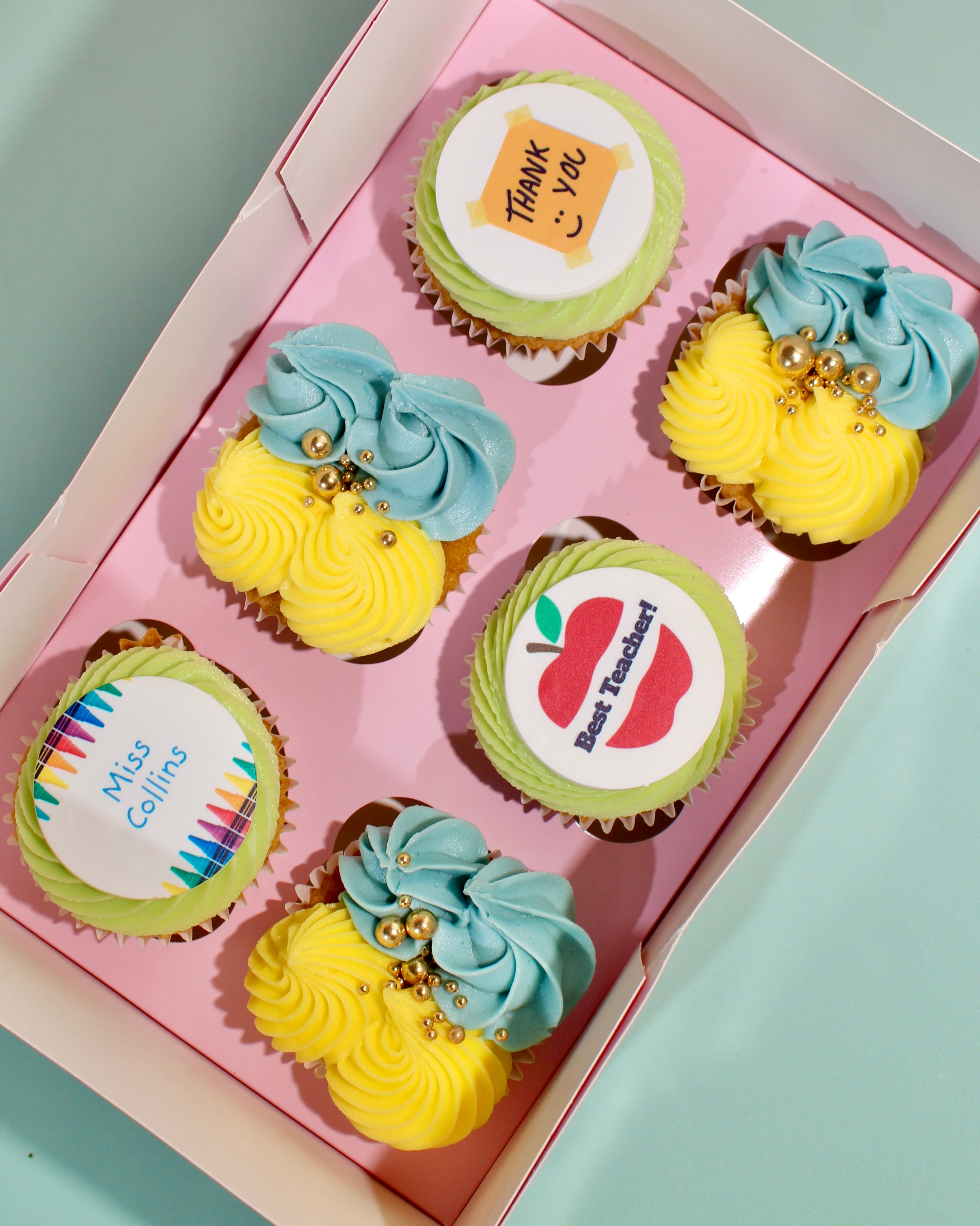 Box of six thank you teacher cupcakes with personalised name disc, Best Teacher apple and Thank You designs
