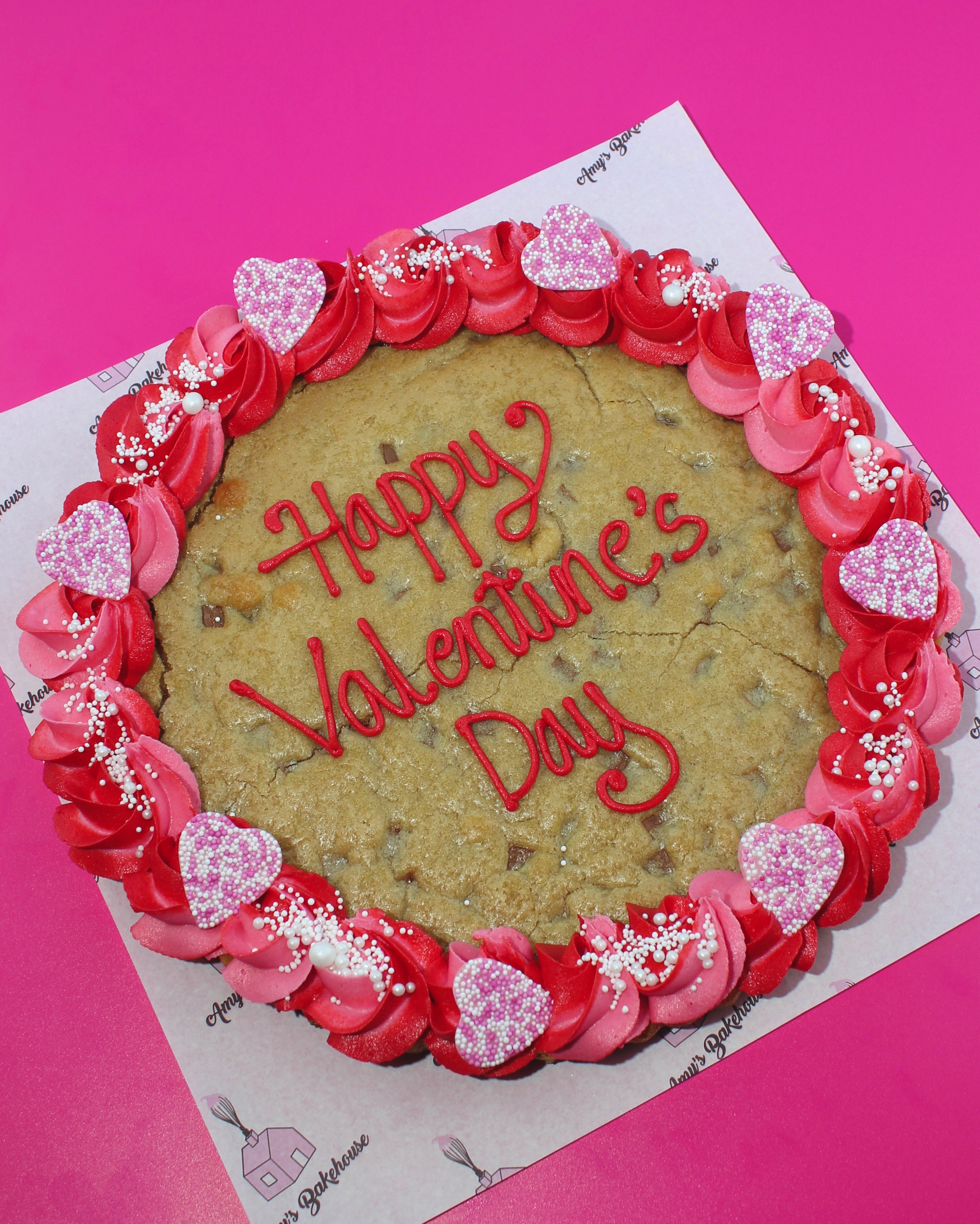 Valentine’s Day giant cookie with pink and red buttercream and piped message