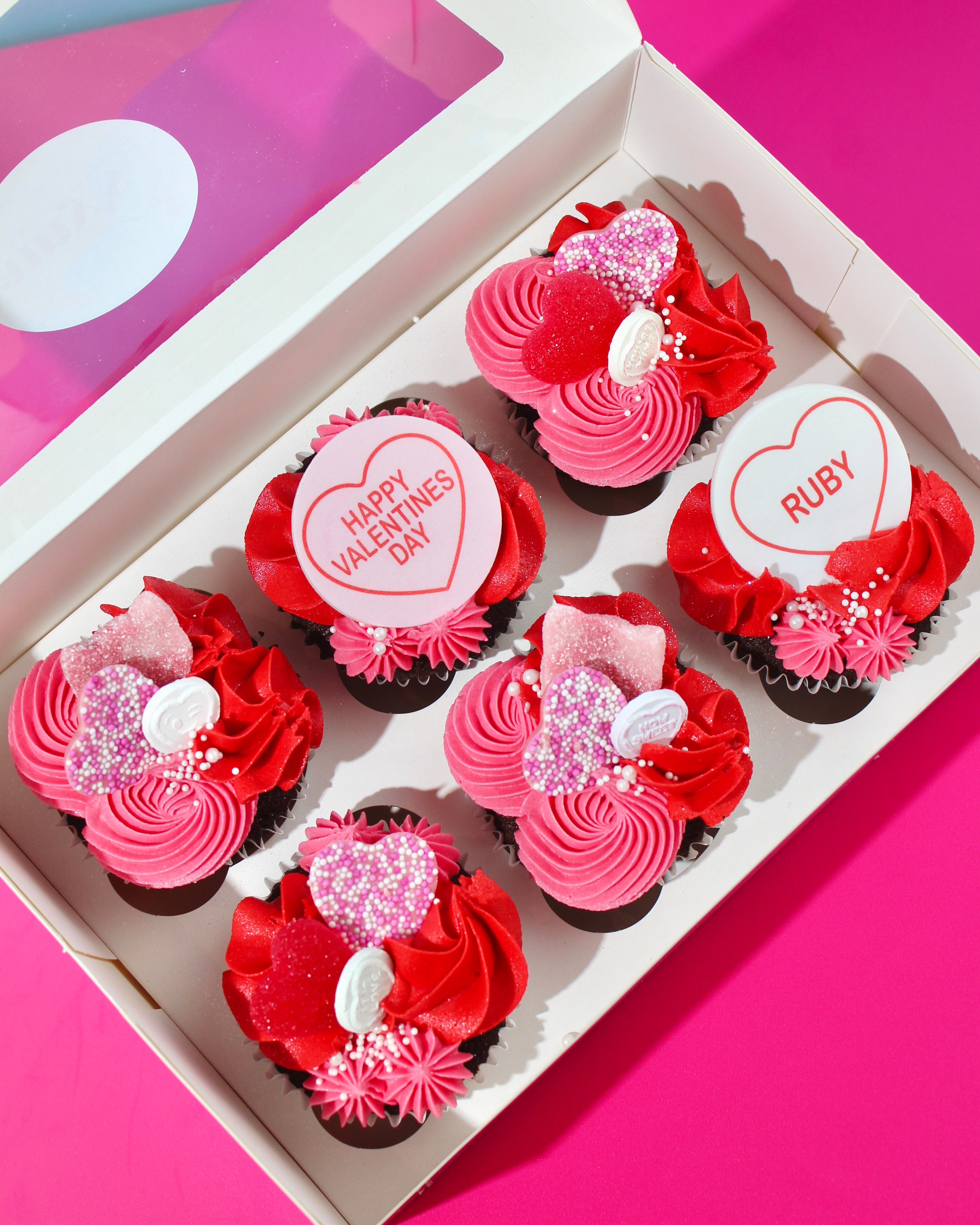 Valentine’s Day cupcakes in pink and red buttercream presented in a gift box