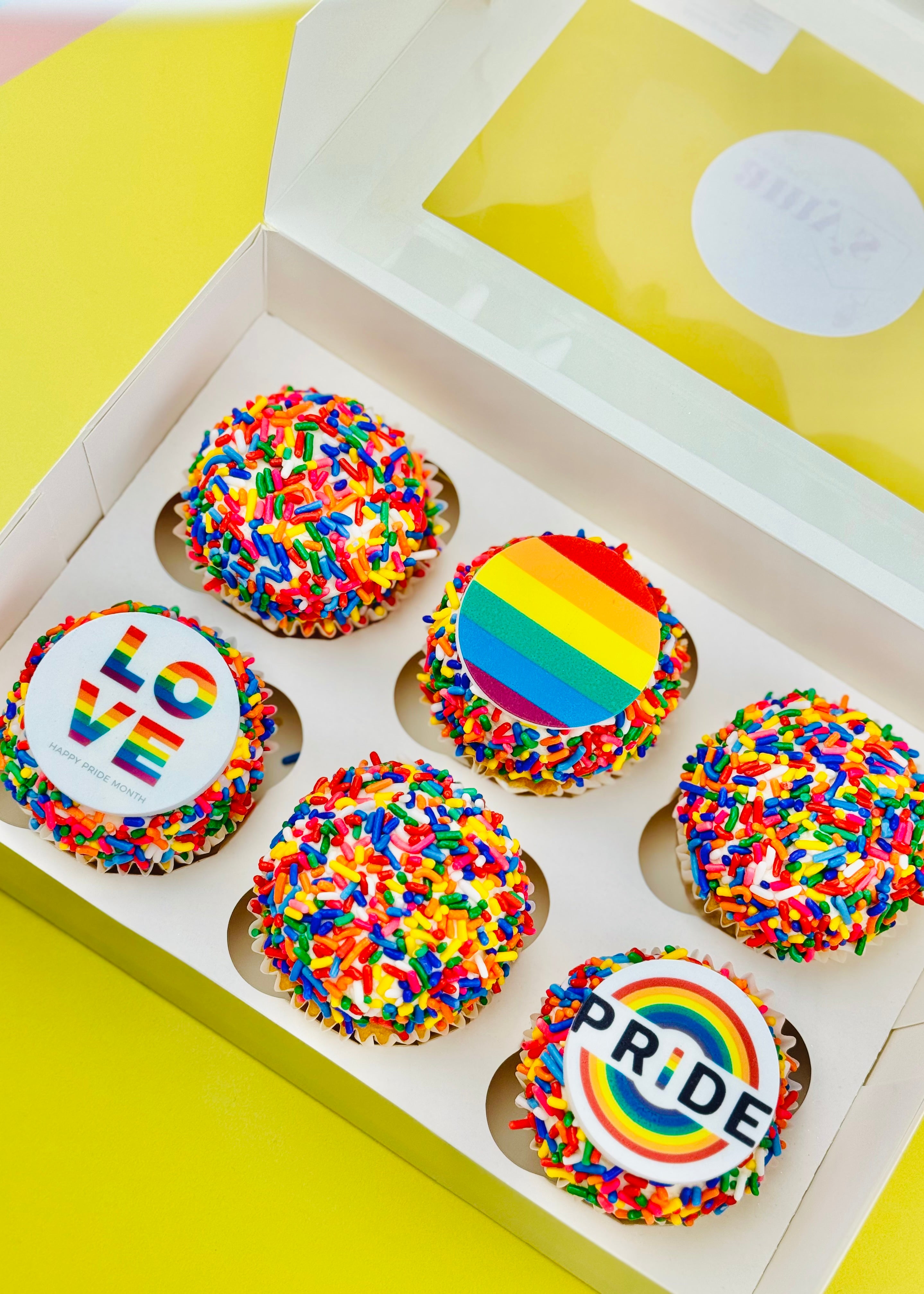 Pride cupcakes with rainbow sprinkles and edible toppers