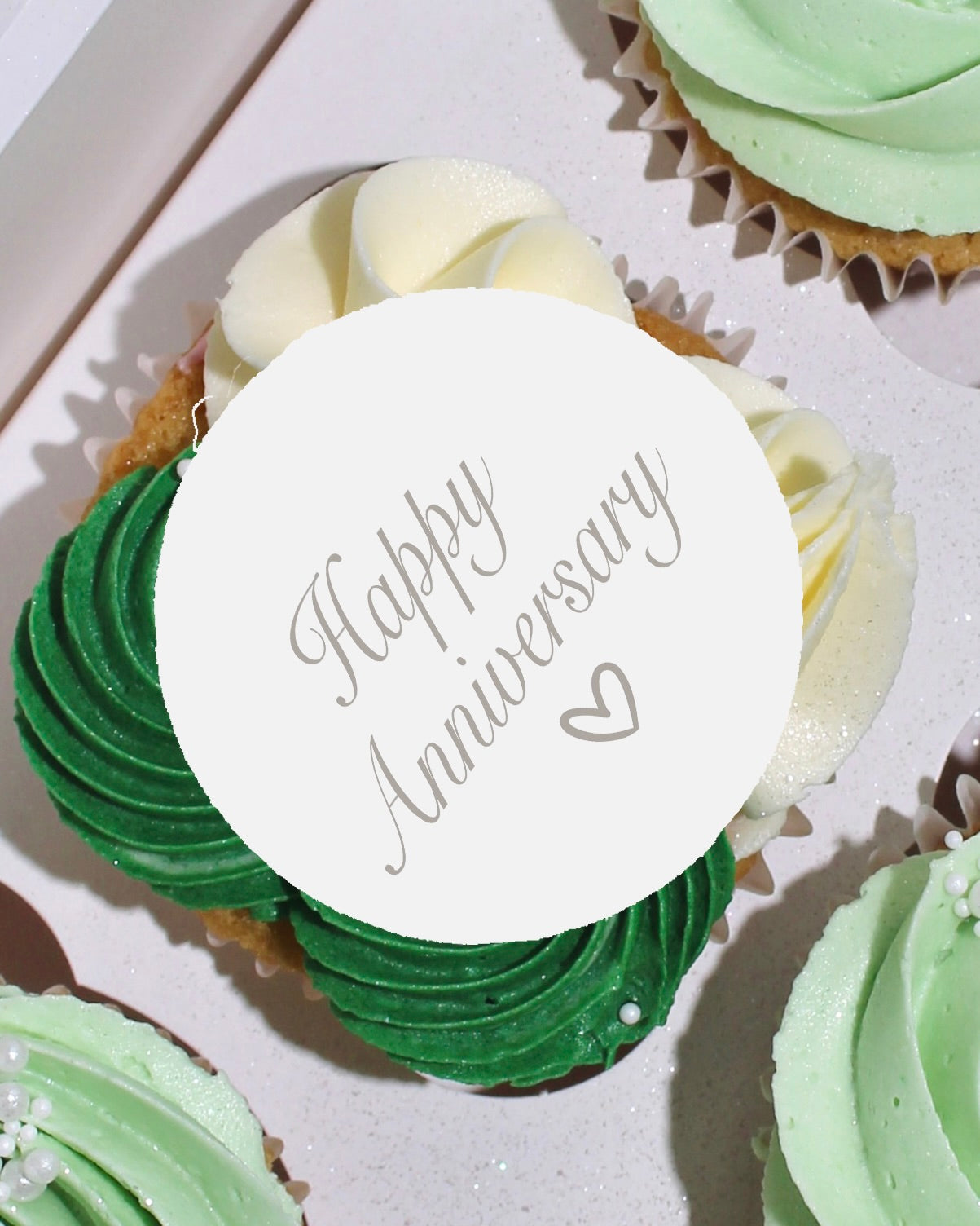Anniversary cupcake with green and white buttercream and personalised edible topper